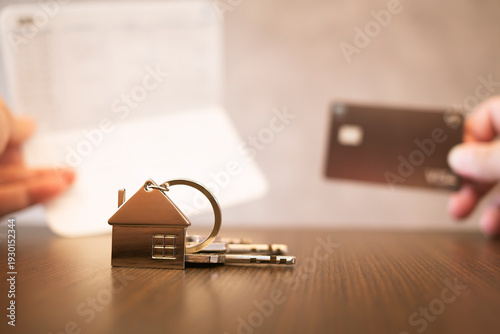 Wallpaper Mural House key with home keychain on table with blurred bank book and credit card. Real estate mortgage loan approval, property purchase agreement, and financial success concept. Torontodigital.ca