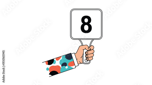 Hand with a colorful spotted sleeve holding up a white paddle with the number eight for judging or scoring purposes.