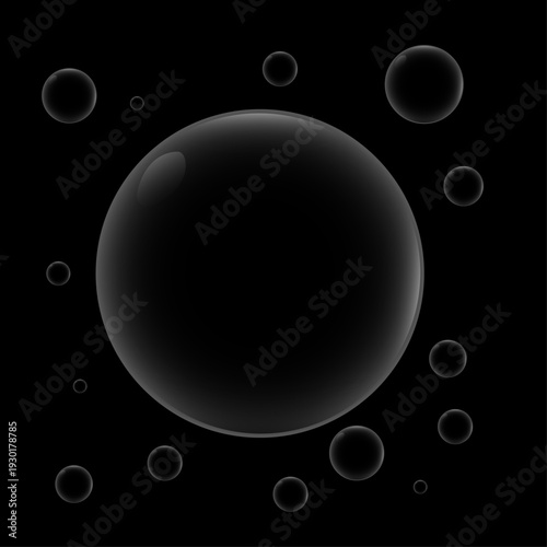 A collection of translucent bubbles in varying sizes against black