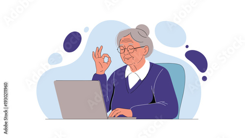 Content senior woman sitting at her personal laptop and making an okay hand gesture with a gentle smile on her face.