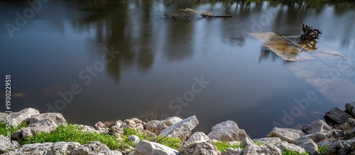 High resolution image of a Calm River Long Exposure with Smooth Water and Natural Stone Shoreline – Serene Nature Background