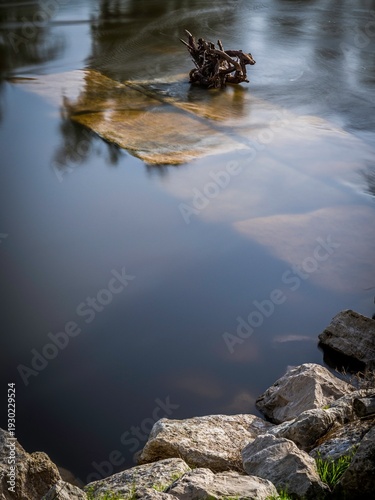 High resolution image of a Calm River Long Exposure with Smooth Water and Natural Stone Shoreline – Serene Nature Background