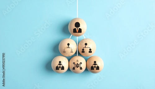 Wooden blocks arranged in pyramid hierarchy with people icons, blue background
