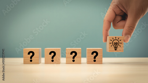Idea selection and decision making concept with hand choosing light bulb block among question mark cubes representing innovation strategy and business problem solving
