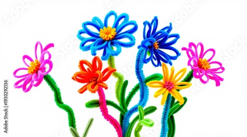 Colorful flowers made from pipe cleaners arranged on a white background in springtime setting