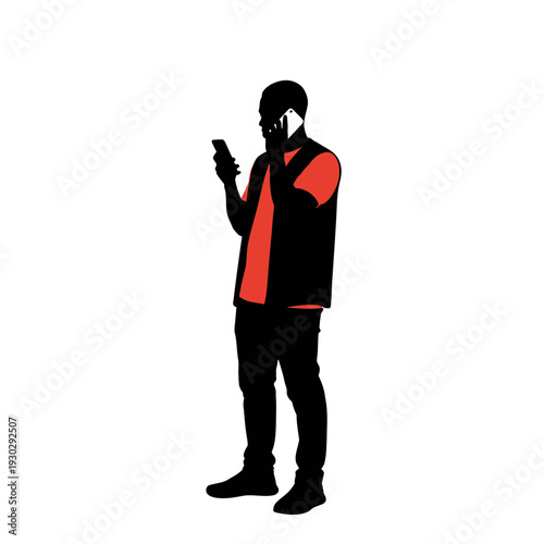 Man in casual outfit engrossed in smartphone in modern urban setting