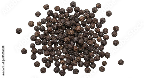 A close-up view of a large number of black peppercorns scattered on a white background.
