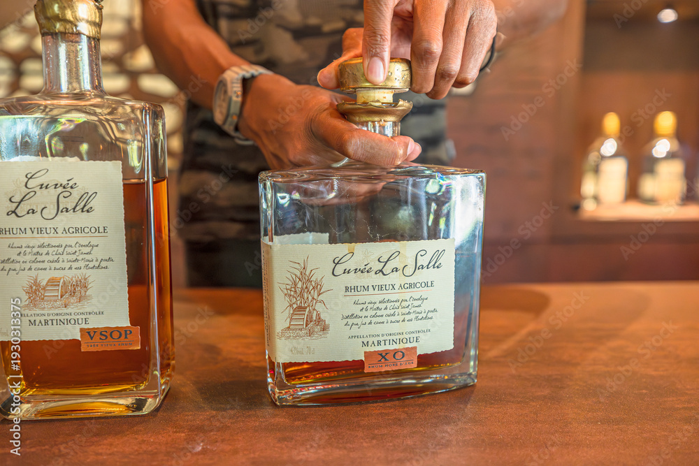 Obraz premium Sainte-Marie, Martinique, French Antilles - Dec 27, 2025: Customer enjoying a rhum tasting experience at Habitation La Salle distillery in Sainte-Marie, Martinique, French Antilles.