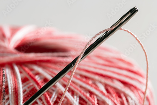 Spool of thread with a needle. Close-up.