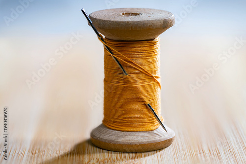 Spool of thread with a needle. Close-up.