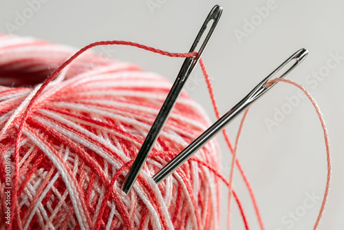 Spool of thread with a needle. Close-up.