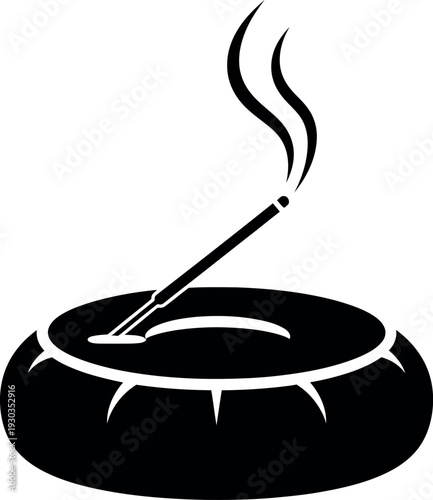 Black silhouette of incense stick burning in a round dish
