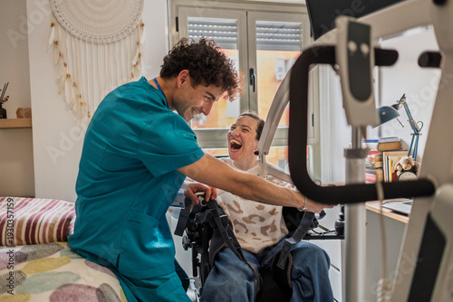 Caregiver helping woman with motor disability using assistive technology