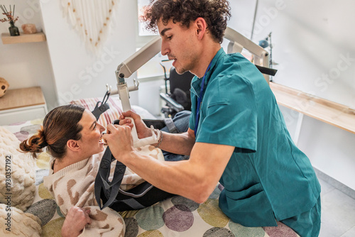 Canvastavla Caregiver assisting patient with mobility transfer using lift system
