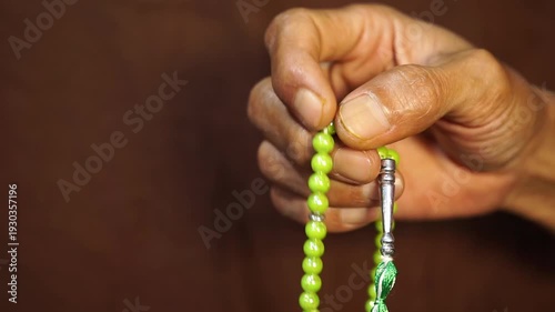 Selective Focus Male Hands Moving Tasbih Beads During Islamic Remembrance - Spiritual Meditation Gesture With Prayer Beads Slow Finger Movement