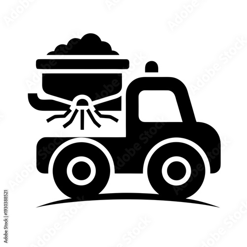 A black and white image of a truck with a large bucket on the back
