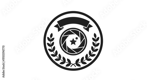 Camera Lens Surrounded by Laurel Wreath Emblem.