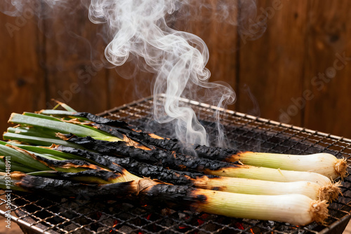 Grilled Calçots: Sizzling on the grill, a mouthwatering display of grilled calçots.  Their charred exterior and succulent interior evoke the essence of traditional culinary delight.