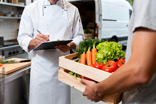 Fresh Produce Delivery: A chef in a pristine kitchen receives a crate of vibrant, fresh vegetables, marking the beginning of a culinary journey.