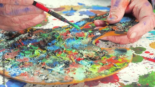 Wallpaper Mural The hands of the artist, work to create creative images in art. Art paints and brushes, applying multi-coloured strokes to the canvas using palette, gouache and watercolour. Torontodigital.ca