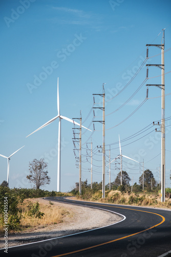 Canvas Print Wind turbines with high voltage electric power lines and pylons along the rural