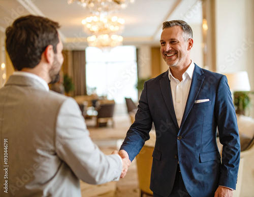 Confident businessmen in suits handshake in a luxury lounge, showcasing professional agreement and partnership. Perfect for corporate success, networking, and business deal themes.