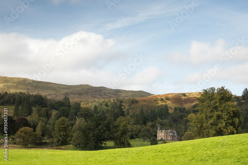 Sunny Scottish countryside landscape with hills in the background