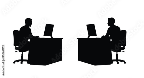 Two men working at desks with computers a striking silhouette