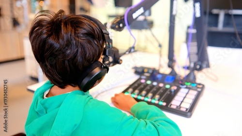 Photos Young person broadcasting, recording a podcast, creating audio content in a prof