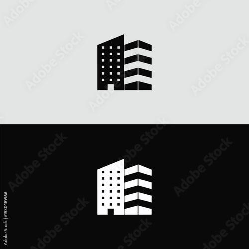 A distinctive black and white icon featuring two separate buildings with contrasting facades – one dotted and one striped – against a split light grey and black background.