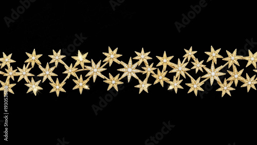 Starfish arranged in a row on black.