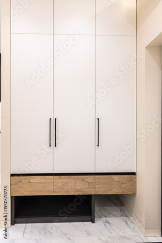 Built in white wardrobe with wood accent base