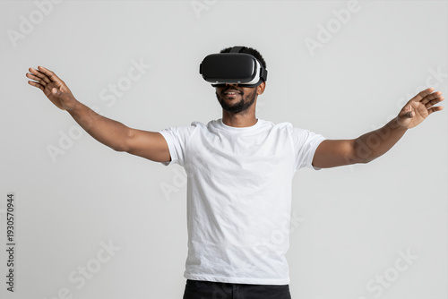 Wallpaper Mural Man Wearing Virtual Reality Headset with Arms Outstretched Enjoying Immersive VR Experience Against Plain Background Torontodigital.ca