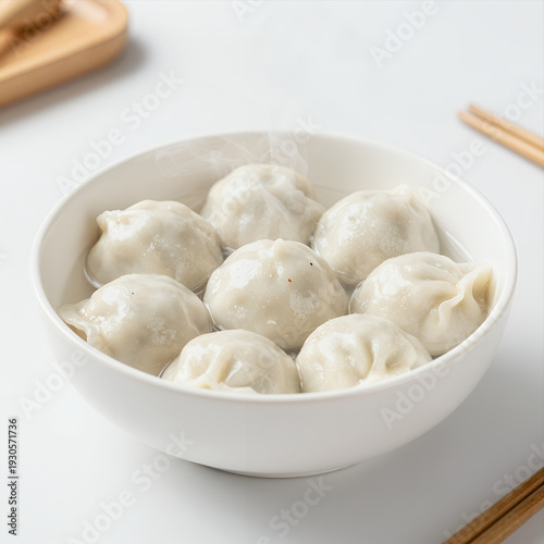 Wallpaper Mural Steaming Bowl of Dumplings in Clear Broth with Wooden Chopsticks on White Surface Food Photography for Restaurant Menu or Recipe Website Torontodigital.ca