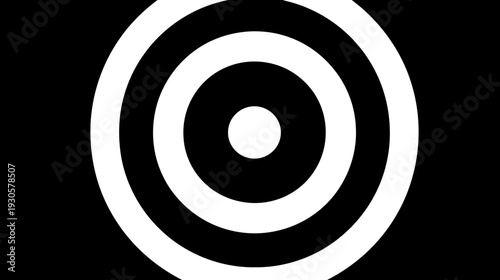 A black and white image features concentric circles, resembling a target or bullseye pattern