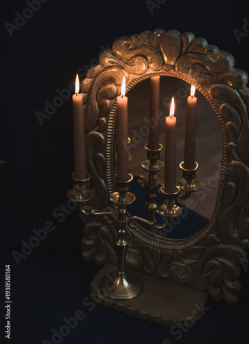Mystical Mirror Reflection with Burning Candles in Vintage Candelabra on Dark Background
