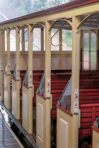 Vintage Tram Interior with Red Wooden Seats and Yellow Interior