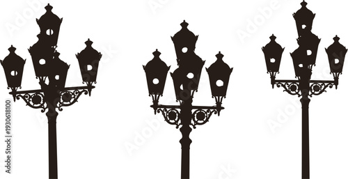 Three victorian style street lamps silhouette