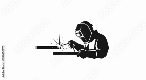 Black silhouette of a welder in protective gear working on metal
