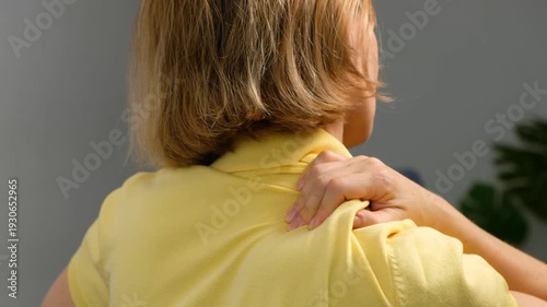 Blonde Woman 40+ Suffering from Shoulder and Trapezius Muscle Pain at Home