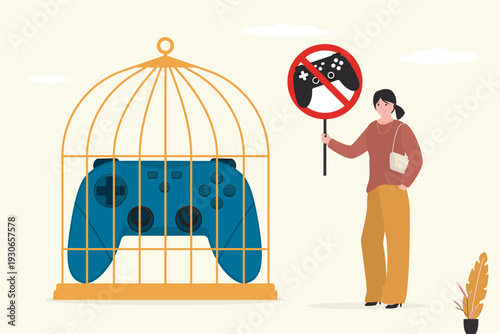 No gaming. Game joystick closed in birdcage. Quit games. Stop play video games. Young woman holding placard - refuse cyber gaming.