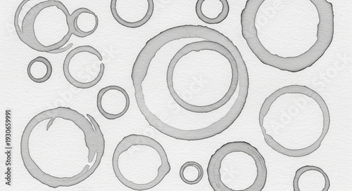 Abstract circular coffee cup stains on white paper background.
