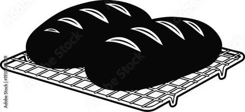 Two loafs of bread on a cooling rack