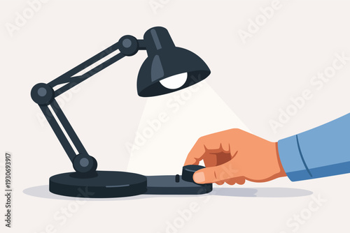 Hand turning on a desk lamp, activating illumination for a workspace or idea