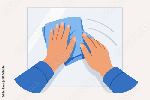 Hands cleaning glass surface with blue rag, illustrating hygiene and sanitation