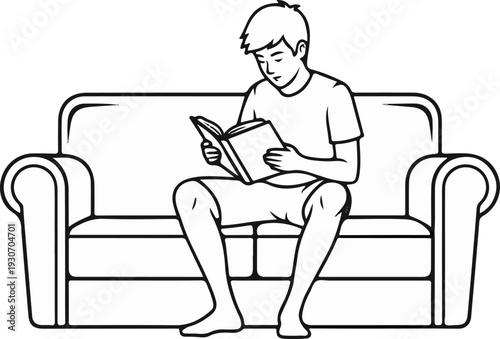 Young person sitting on a sofa and reading a book