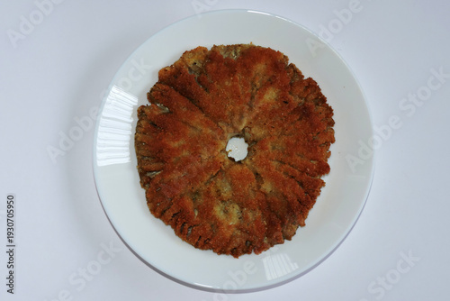 Wallpaper Mural Fried breaded parasol mushroom cap on a white plate showing textured gills on the underside, top view Torontodigital.ca