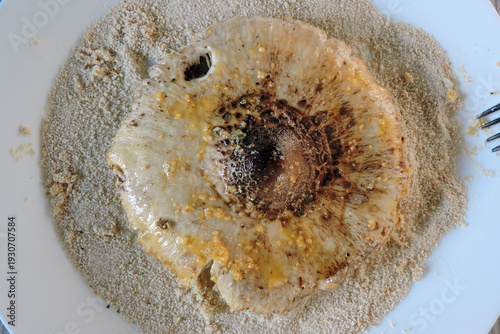 Wallpaper Mural Preparing a parasol mushroom schnitzel: a mushroom cap with breadcrumbs on a plate Torontodigital.ca