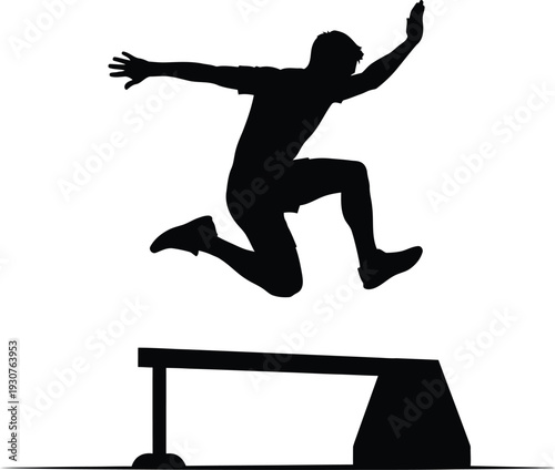 Athlete in mid jump over a hurdle during track and field event