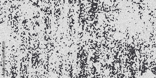 Abstract grayscale textured background with irregular dark organic shapes and fine granular speckles creating a distressed or mottled effect suitable for grunge or vintage designs